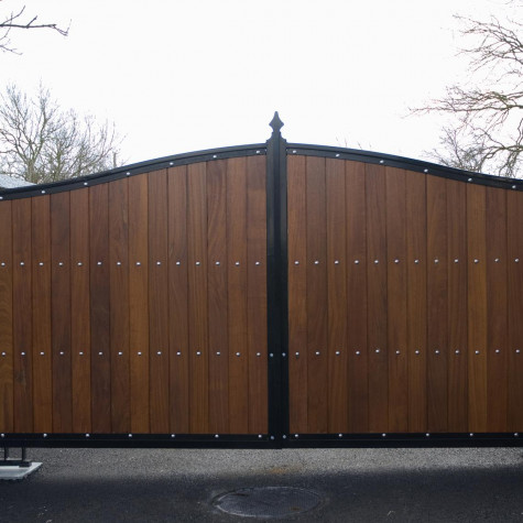 Timber Driveway Gate with Black Metal Frame and Arched Top