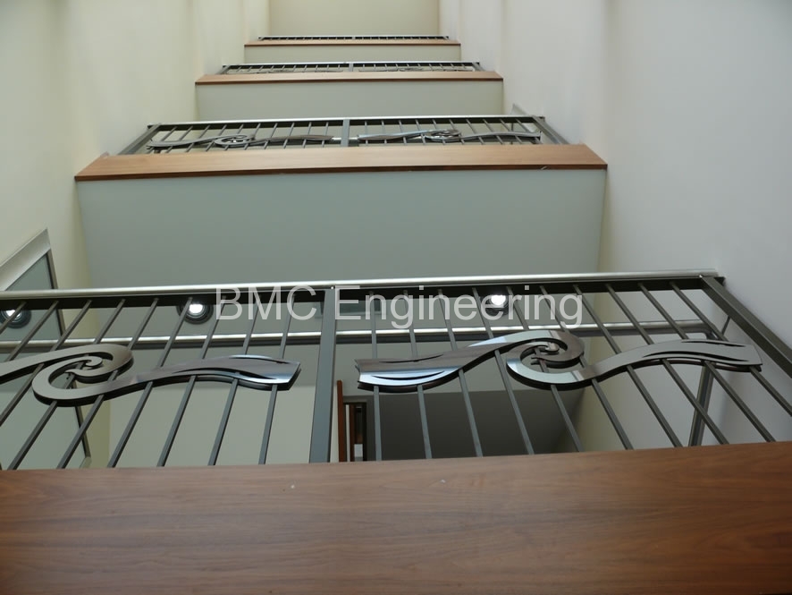 Contemporary Interior Balustrade with Wave-Motif Stainless Steel Inlays
