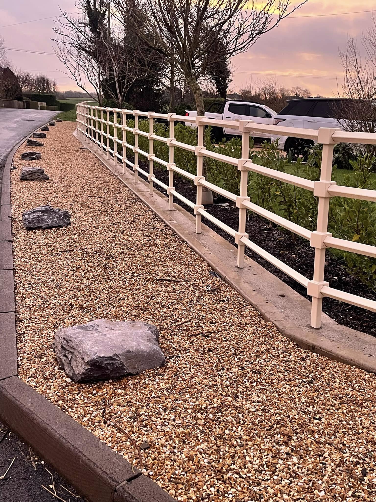 Landscaped Roadside Gravel Bed with White Safety Rail