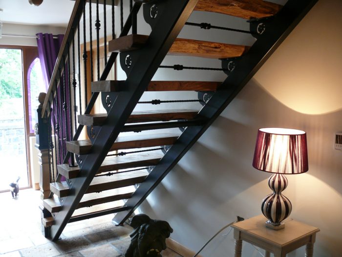 Industrial-Rustic Open-Tread Staircase with Wrought Iron Detailing