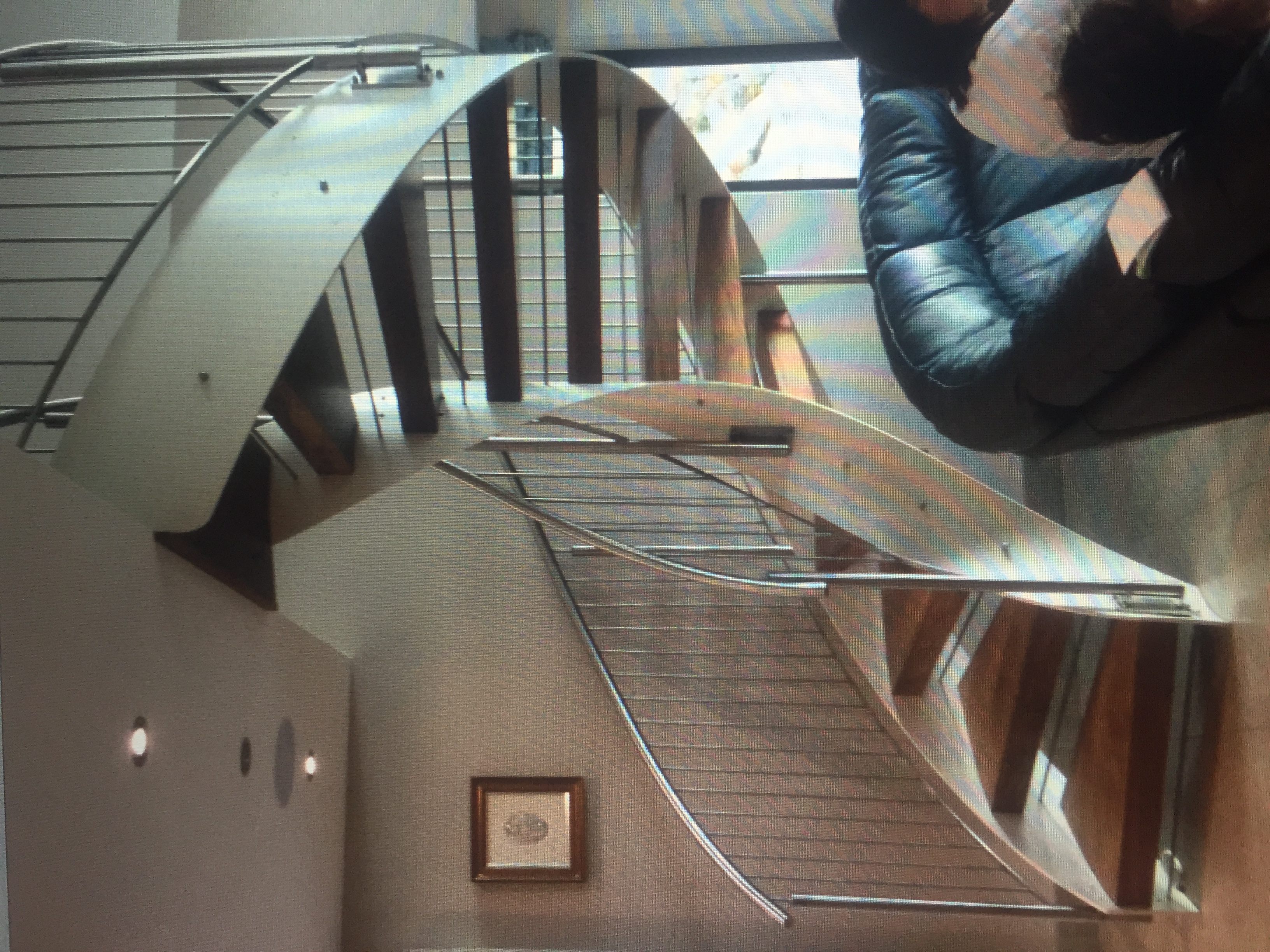 Curved Open-Tread Staircase with Stainless Steel Balustrade